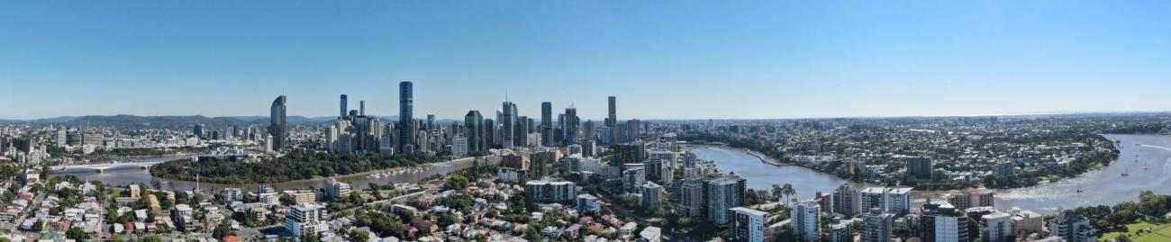 Panorama photograph of Brisbane city, including buildings and the river 